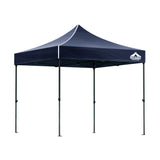 Navy pop up gazebo shown providing shade at an outdoor event