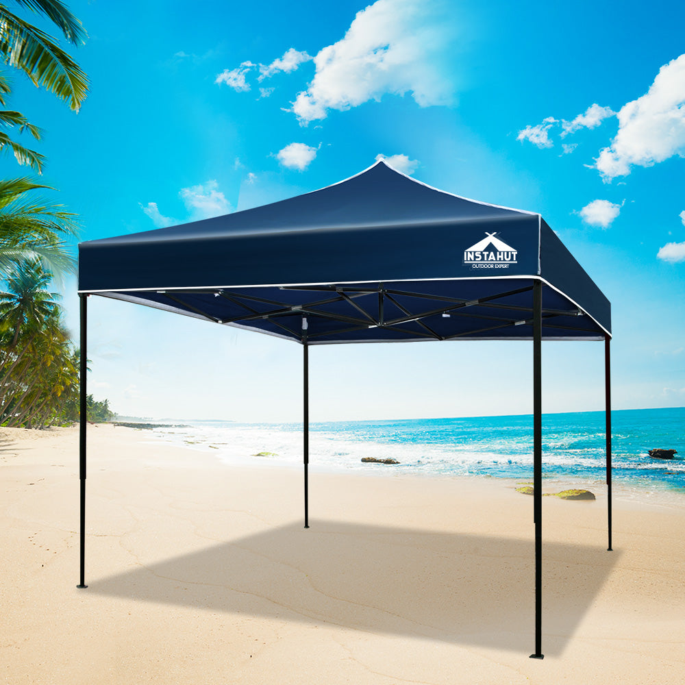 Navy pop up gazebo partly folded during set up