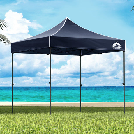 Navy 3 x 3 m pop up gazebo set up outdoors with open sides