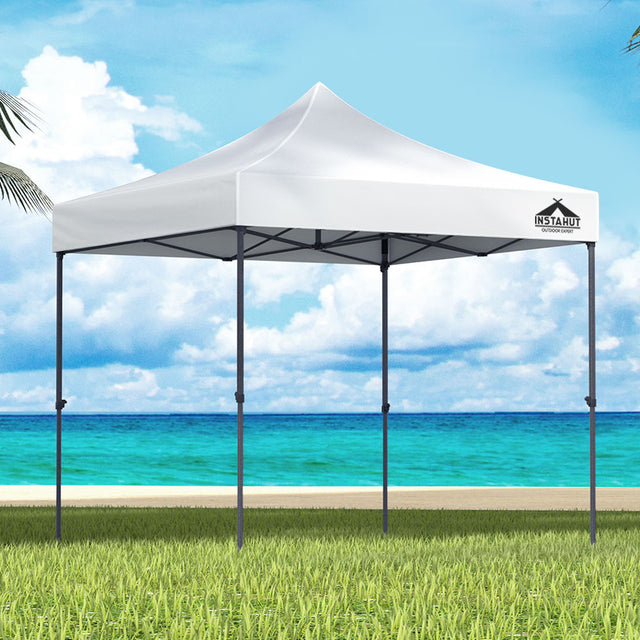 White 3 x 3 m pop up gazebo set up outdoors with open sides