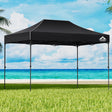 Black 4.5 x 3 m pop up gazebo set up outdoors with open sides