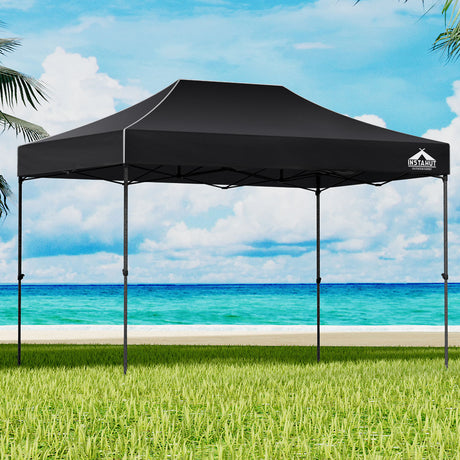 Black 4.5 x 3 m pop up gazebo set up outdoors with open sides