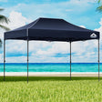 Navy 4.5 x 3 m pop up gazebo set up outdoors with open sides