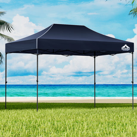 Navy 4.5 x 3 m pop up gazebo set up outdoors with open sides