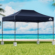 Navy 3 x 4.5 m pop up gazebo with four base pods set up outdoors