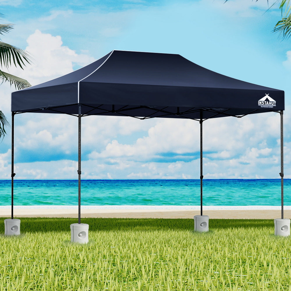 Navy 3 x 4.5 m pop up gazebo with four base pods set up outdoors