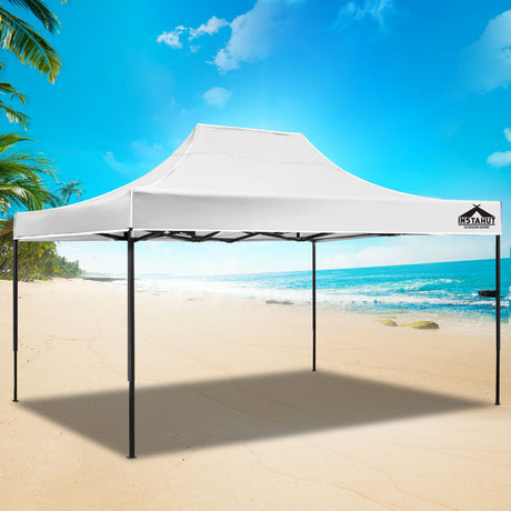 White pop up gazebo used as a shaded market stall with tables underneath