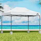 White 3 x 4.5 m pop up gazebo with four base pods set up outdoors