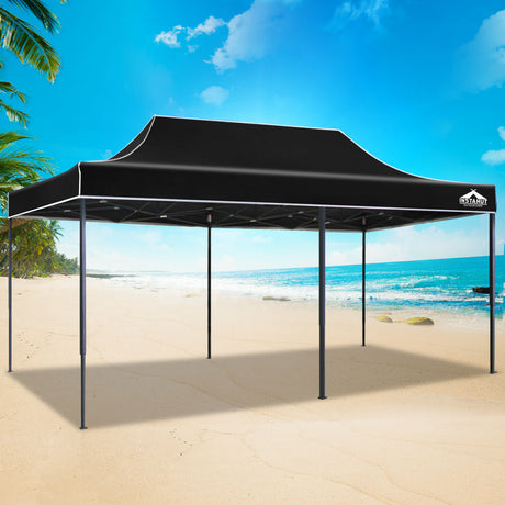 Black pop up gazebo folded down to its compact size for storage
