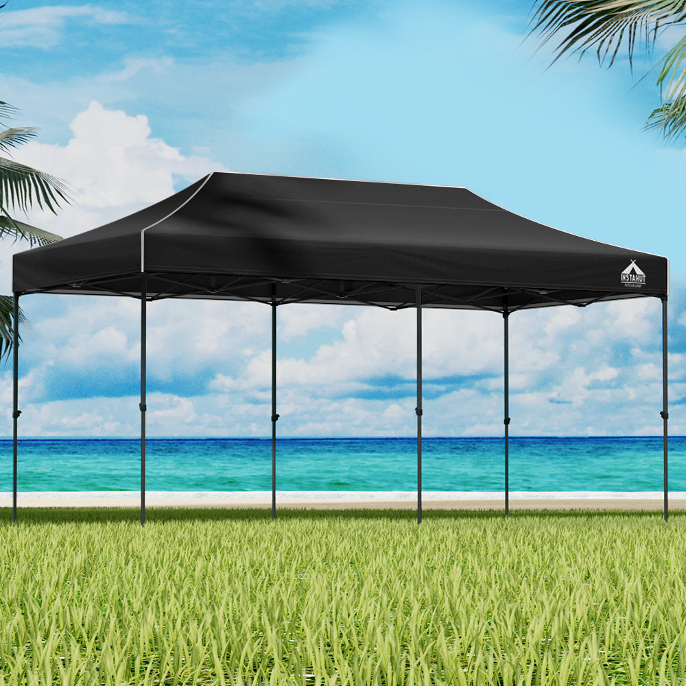 Navy 6 x 3 m pop up gazebo set up outdoors with open sides