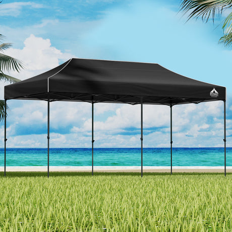 Navy 3 x 6 m pop up gazebo marquee set up outdoors with open sides