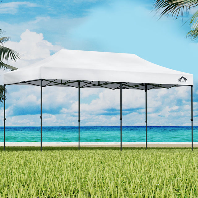 White 6 x 3 m pop up gazebo set up outdoors with open sides
