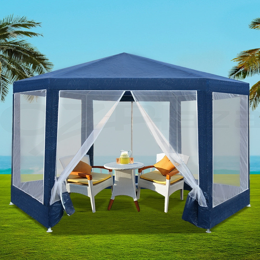 Navy hexagonal gazebo with mesh walls set up outdoors for a party