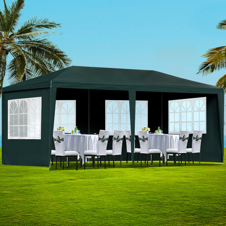 Green 3 x 6 m marquee gazebo set up outdoors with window side panels fitted