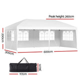 Angled view of the white marquee tent showing the peaked roof and side wall windows