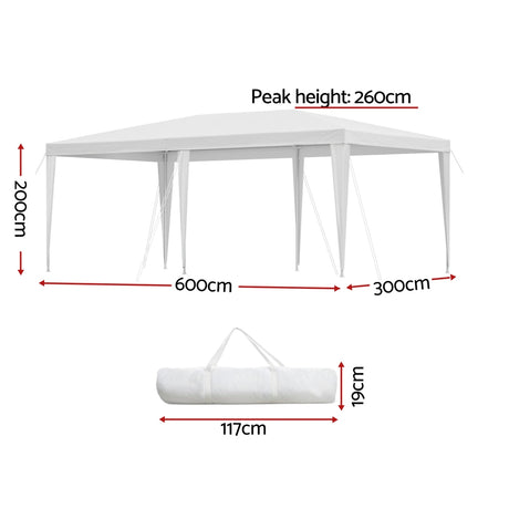 White marquee gazebo shading an outdoor wedding seating area