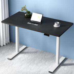 Manuka black electric standing desk with white frame in a home office