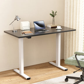 Manuka black electric standing desk with white frame in a home office
