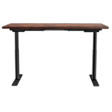 Braddon rustic brown electric standing desk with black frame in a home office