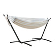 Cream outdoor hammock on a stand in a backyard