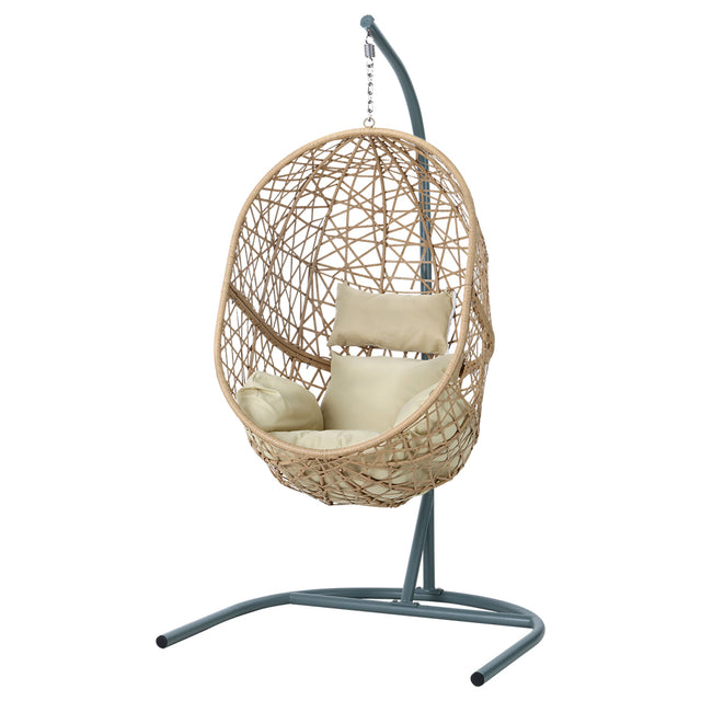 Vincentia yellow resin wicker hanging egg chair with stand on a patio