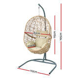 Vincentia yellow resin wicker hanging egg chair with stand on a patio