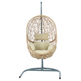 Vincentia yellow resin wicker hanging egg chair with stand on a patio