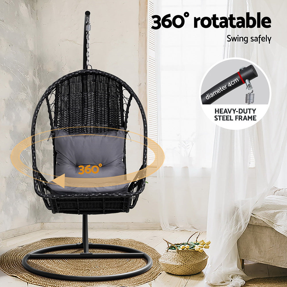 Gerroa black resin wicker hanging egg chair with stand on a patio
