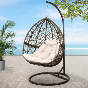 Tuross Head outdoor egg swing chair with hand woven wicker and stand on a patio