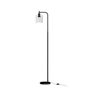 Hartley black floor lamp with glass shade in a modern study
