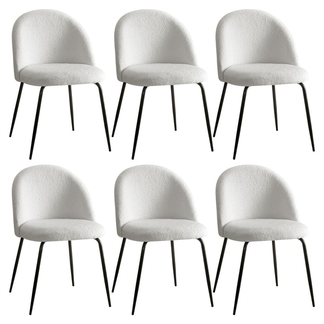 Hahndorf white sherpa winged dining chairs with steel legs around a dining table
