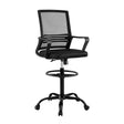 Northcliffe black mesh drafting chair with foot ring at a standing desk