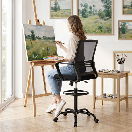 Northcliffe black mesh drafting chair with foot ring at a standing desk