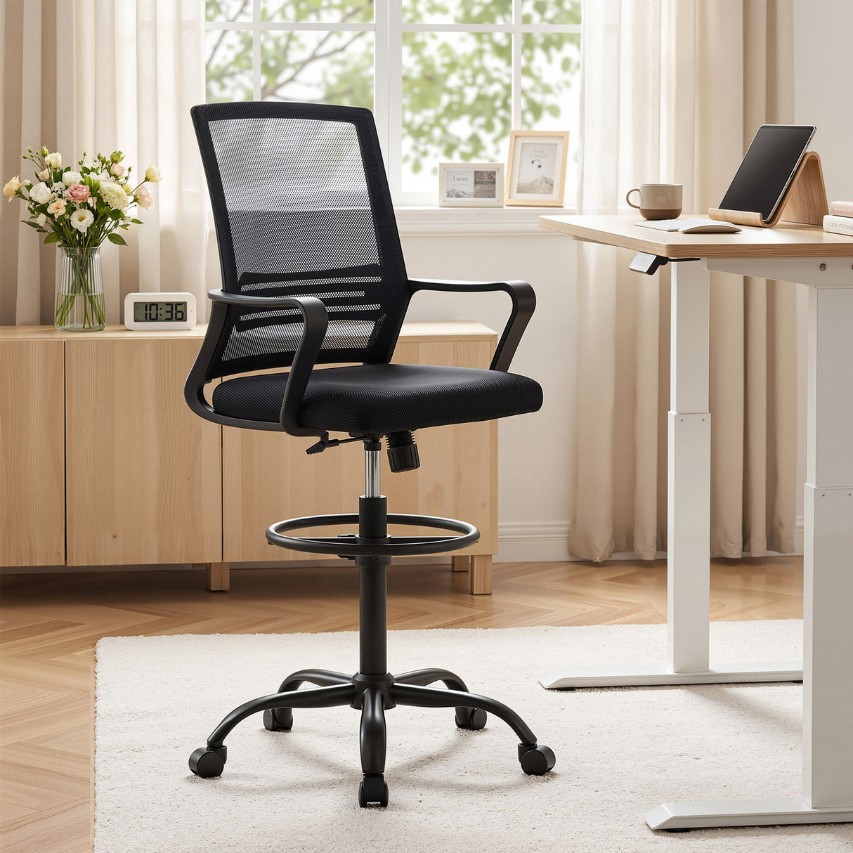 Northcliffe black mesh drafting chair with foot ring at a standing desk