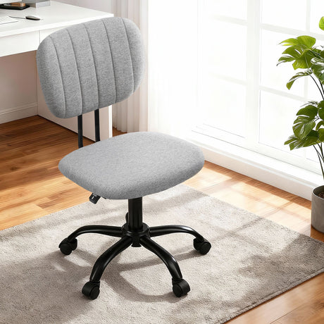 Pingelly grey armless fabric office chair in a small home office