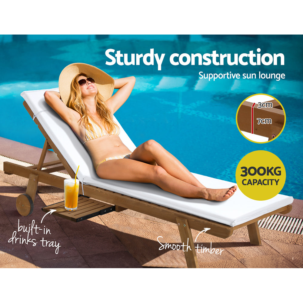 Gerringong natural wood sun lounger with white cushion and wheels on a patio