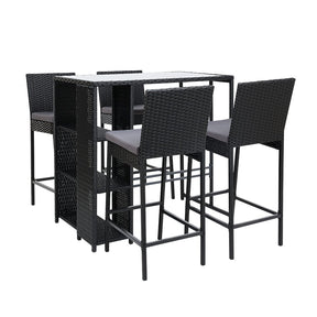 Nobby Beach 5 piece outdoor wicker bar set with table stools and dining chairs on a deck