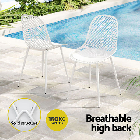 Hyams Beach set of four white polypropylene outdoor dining chairs on a patio