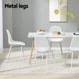 Hyams Beach set of four white polypropylene outdoor dining chairs on a patio