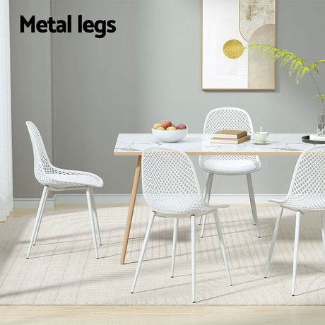 Hyams Beach set of four white polypropylene outdoor dining chairs on a patio