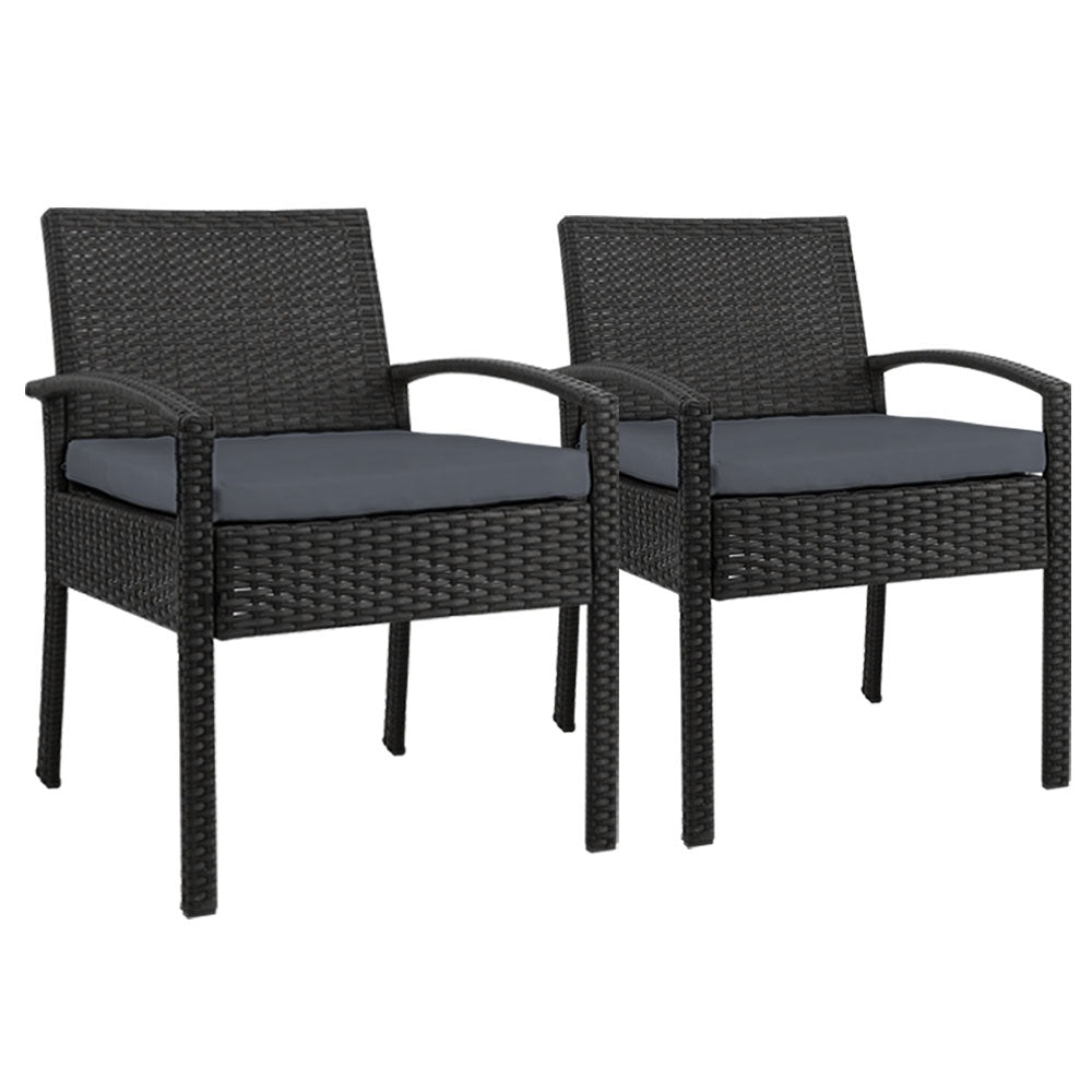 Ulladulla pair of black PE wicker outdoor dining chairs with cushions on a patio