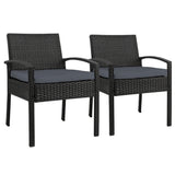 Ulladulla pair of black PE wicker outdoor dining chairs with cushions on a patio