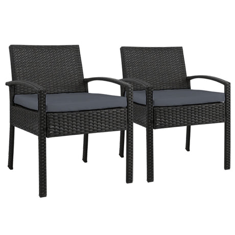 Ulladulla pair of black PE wicker outdoor dining chairs with cushions on a patio