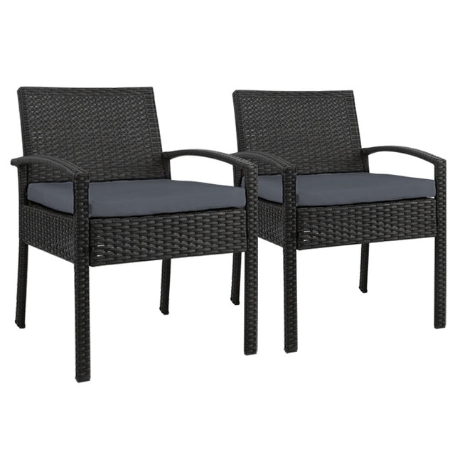 Ulladulla pair of black PE wicker outdoor dining chairs with cushions on a patio
