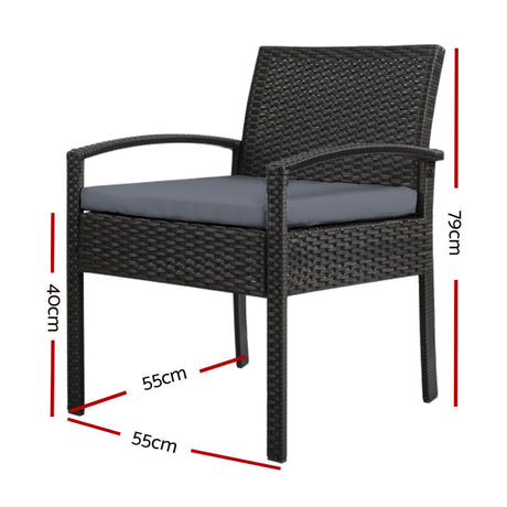 Ulladulla pair of black PE wicker outdoor dining chairs with cushions on a patio
