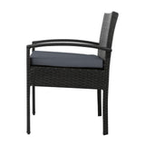 Ulladulla pair of black PE wicker outdoor dining chairs with cushions on a patio