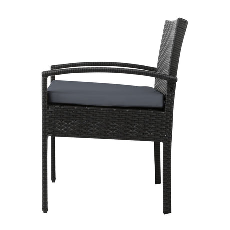 Ulladulla pair of black PE wicker outdoor dining chairs with cushions on a patio