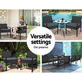 Ulladulla pair of black PE wicker outdoor dining chairs with cushions on a patio