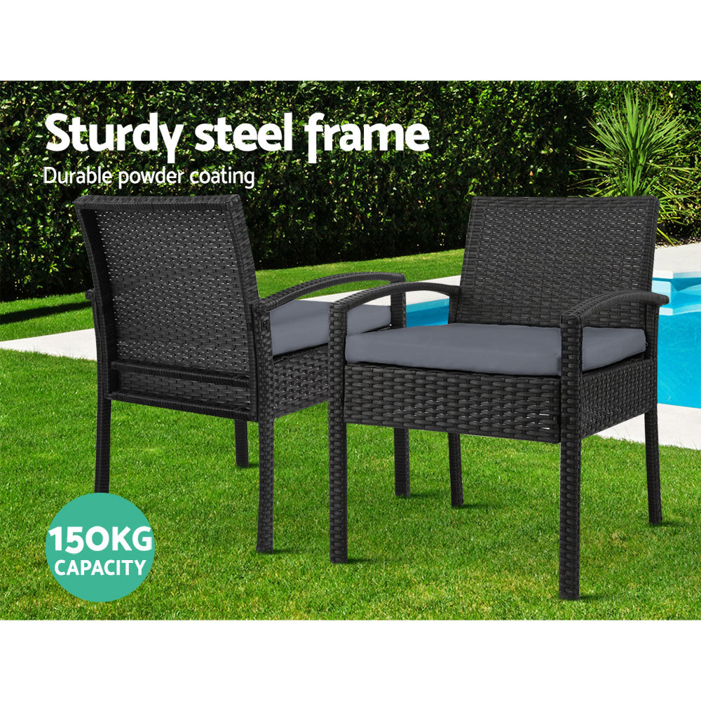Ulladulla pair of black PE wicker outdoor dining chairs with cushions on a patio