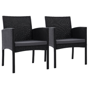 Berry black wicker outdoor dining chairs with grey cushions on a deck